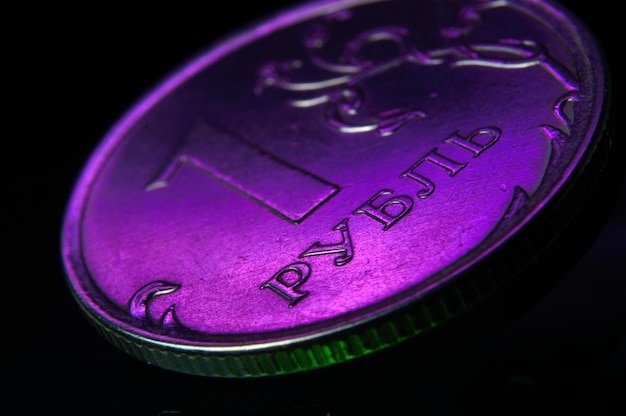 Russian 1 ruble coin is illuminated with magenta light. close-up.