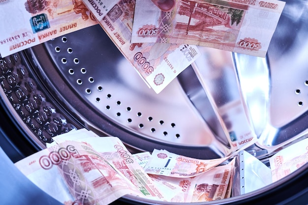 Russian banknotes in the washing machine Money laundering financial fraud concept