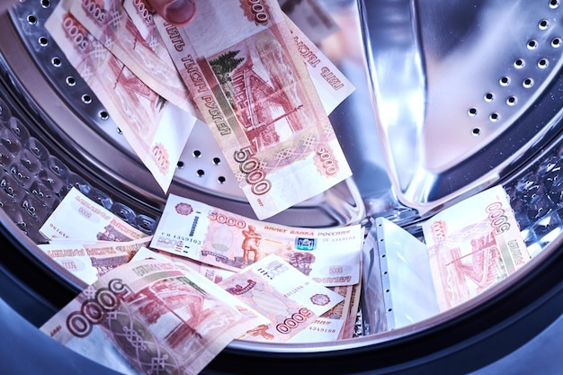 Russian banknotes in the washing machine Money laundering financial fraud concept