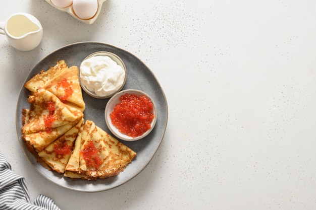 Russian blini with red caviar and sour cream shrovetide