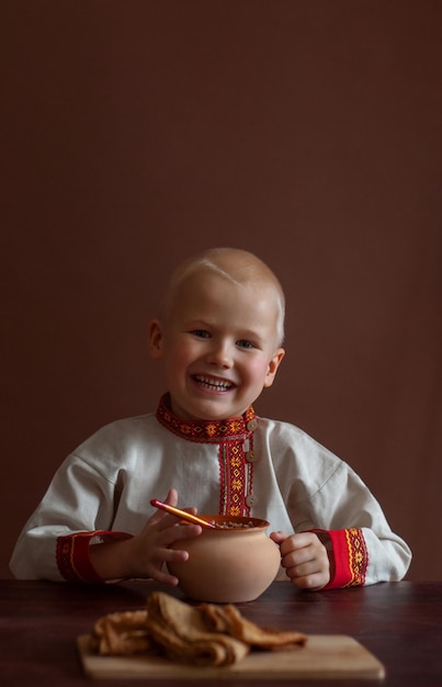 Russian boy in traditional clothes Maslenitsa Russian traditional costume Russia