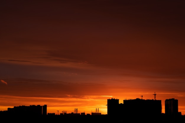 russian city at sunset with buildings and colorful sky.