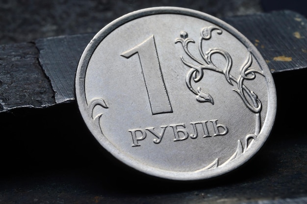 Russian coin denominated 1 ruble shines on a scratched metal surface closeup translation of the text on the coin quot1 rublequot