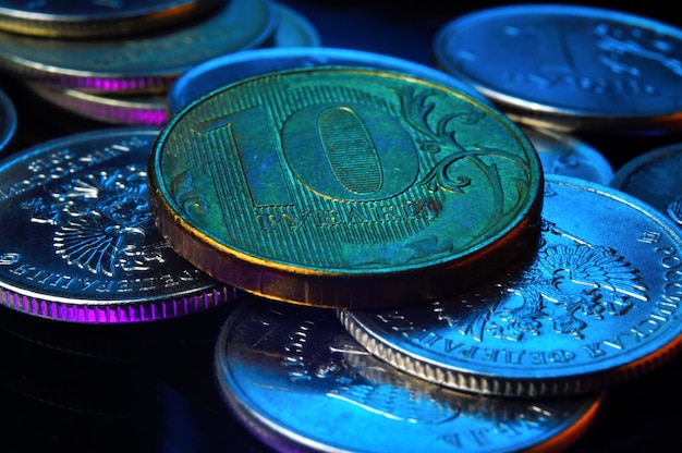 Russian coin with a denomination of 10 rubles is highlighted in blue and light. close-up.