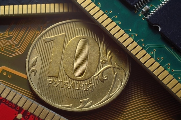 Russian coin with a face value of 10 rubles lies among the microcircuits a concept illustrating the pricing of electronics in Russia