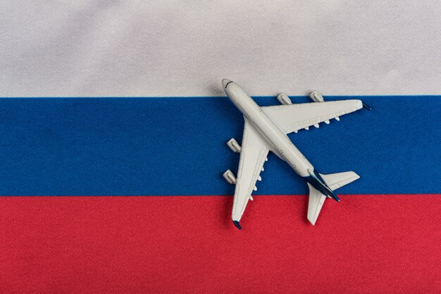 Russian Federation flag and toy airplane close up. Resumption of flights after quarantine, opening borders