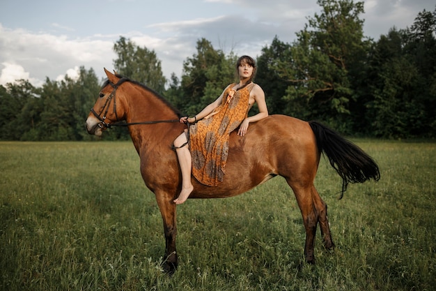 Russian girl on a horse, spring nature, man and animal