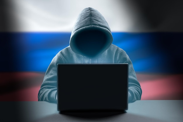 Russian Hacker attack Dangerous Hooded Hacker Breaks into Government Data Servers Cybersecurity computer hacker with hoodie Hacking and malware concept