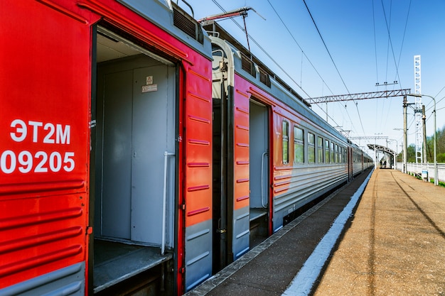 The Russian Railways train at the station with open doors. Side view.