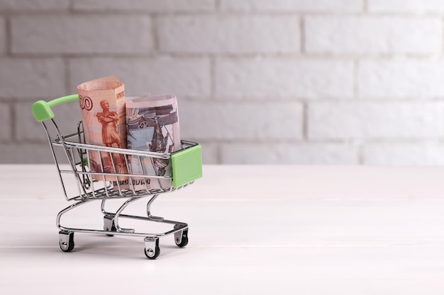 Russian rubles in a mini grocery basket on the table