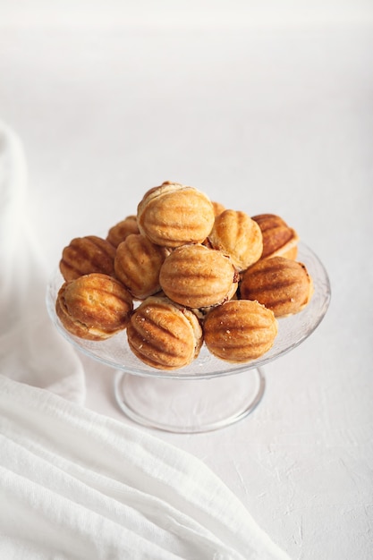 Russian traditional homemade cookies Nuts with condensed milk on a glass stand.