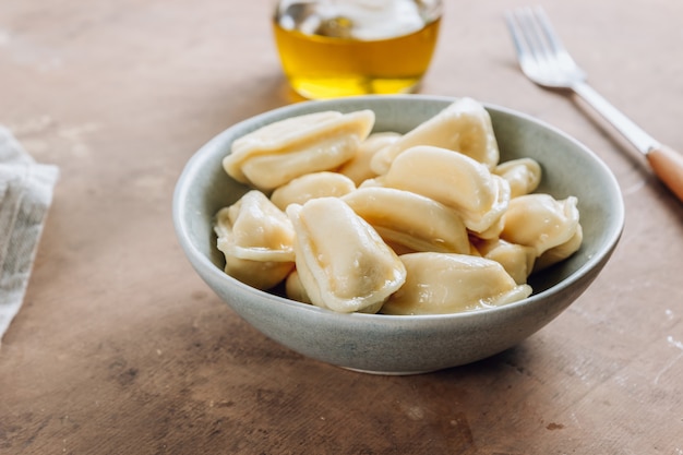 Russian, Ukrainian or Polish dish - varenyky. Dumplings, filled with cottage cheese. Selective focus