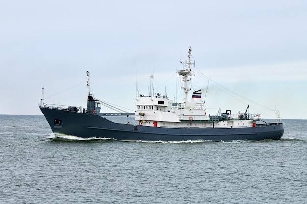 Russian warship armed with armament sails into sea toward military target to attack and destroy