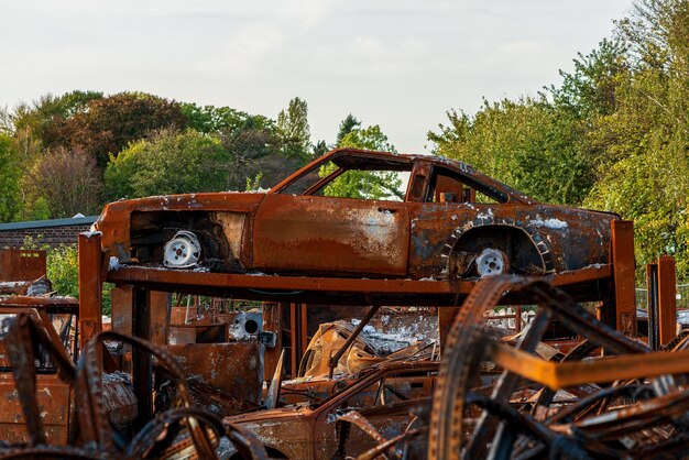 Photo rusted burnt out car wrecks