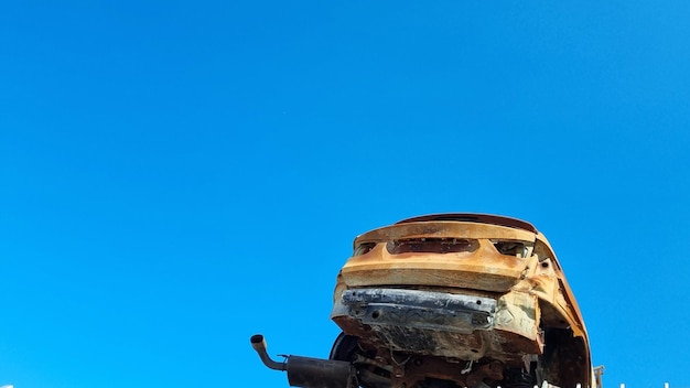 A rusted car with the word auto on it