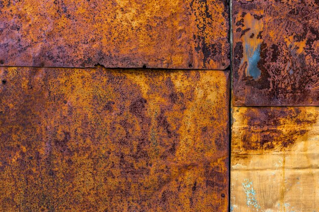 Rusted flat composite nailed metal sheets surface background and texture