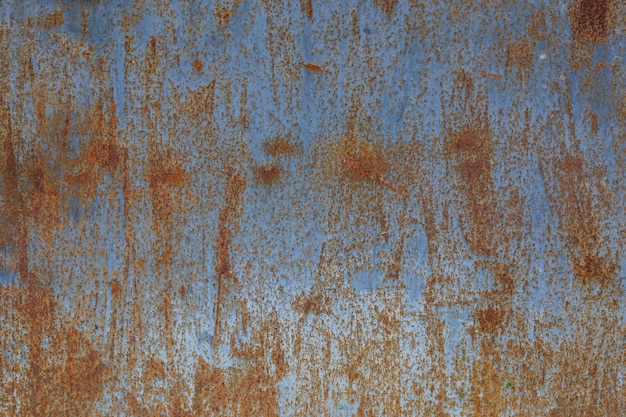 Photo rusted flat solid sheet metal surface background and texture with leftovers of blue paint