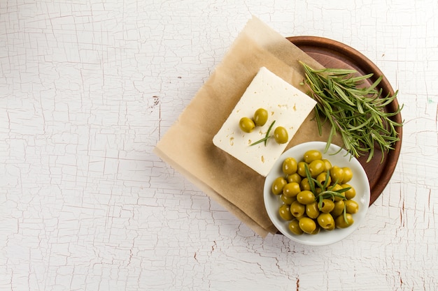 Rustic background with olives and aromatic herb