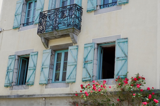 Rustic building facade with traditional windows and shutters in Arreau town HautesPyrenees France