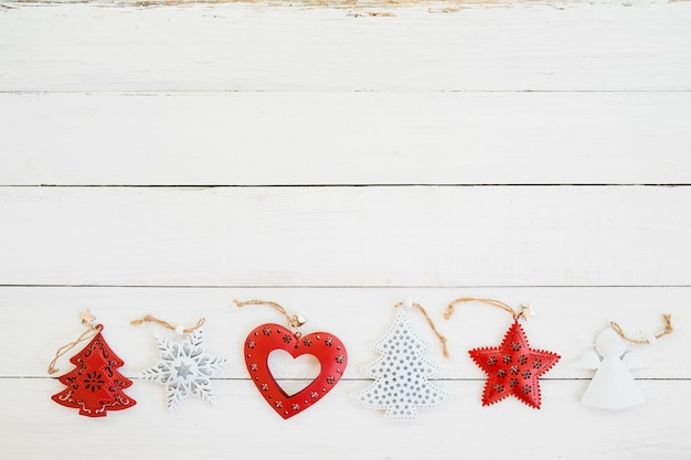 Rustic Christmas decoration and ornament made of metal on white wood background. vintage style, topview.