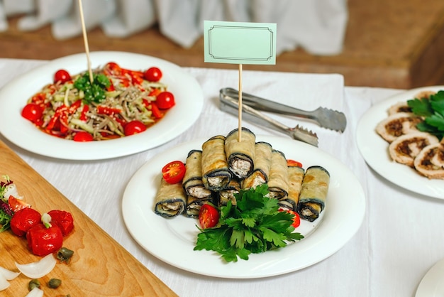 Rustic fried stuffed eggplant with cheese and spices Decorated with parsley tomatoes on white plate