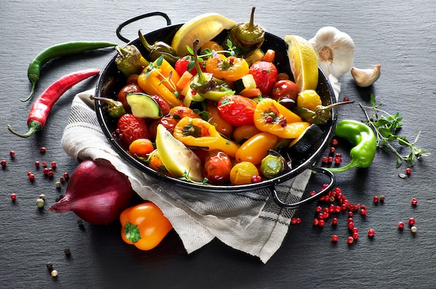 Rustic, oven baked vegetables with spices and herbs in baking dish