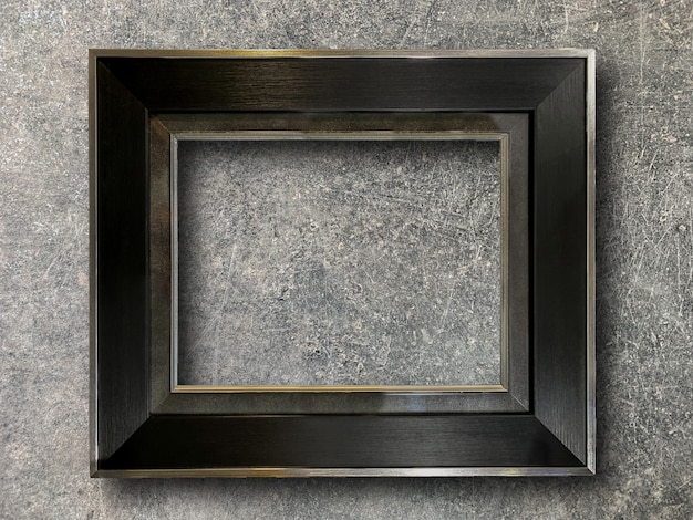 Rustic picture frame on cement wall 