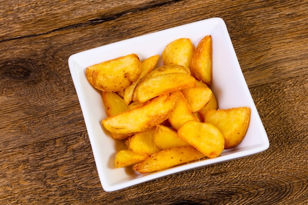 Rustic potato over wooden background