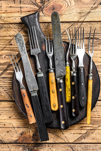 Rustic set of cutlery knife and fork. Wooden table. Top view.