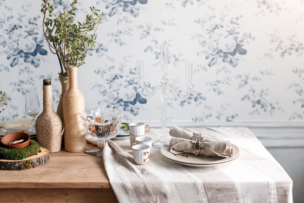 Rustic table setting. Eco friendly design Vintage interior with wood, antique cups, dishes and cutlery