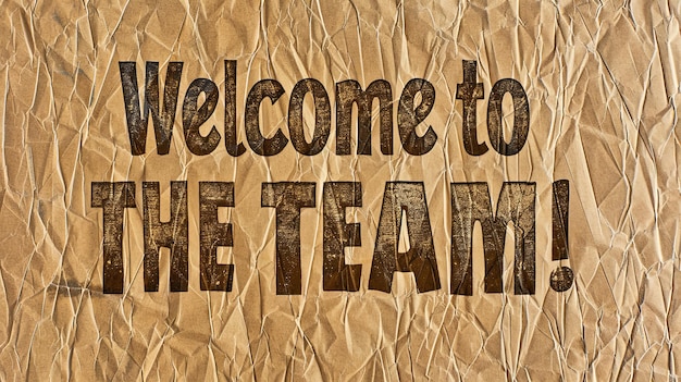 Rustic and textured Welcome to the Team signs on crumpled brown paper perfect for vintagethemed onboarding announcements