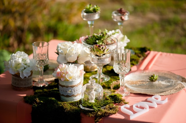 Rustic wedding table setting with succulents and moss