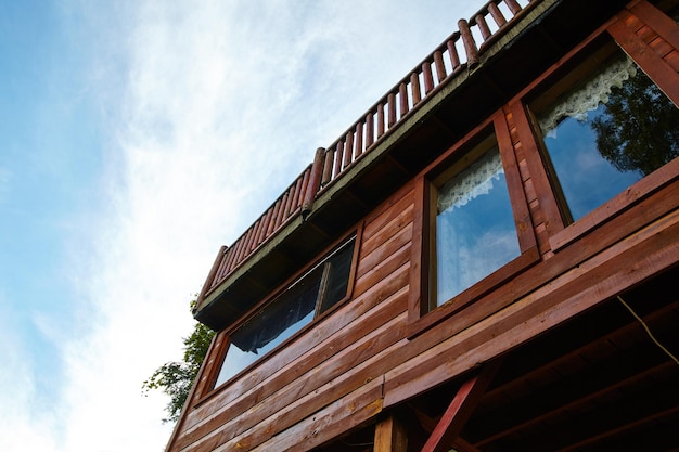 Rustic Wooden Cabin Facade with Sky Reflections