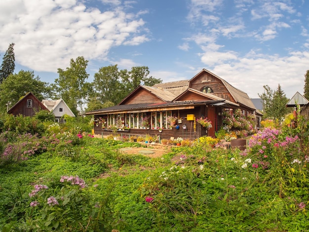 Rustic wooden house with a flower garden Old wooden house