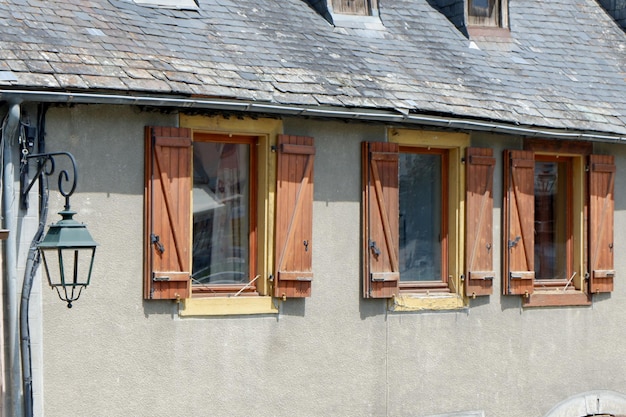 Rustic wooden windows on the vintage french house in Arreau village Pyrenees France