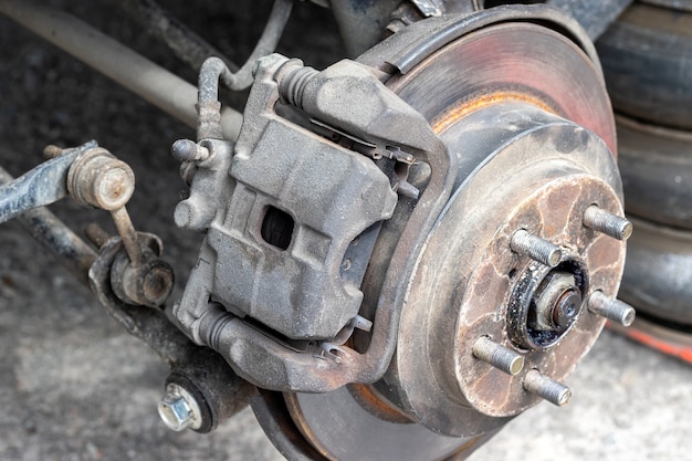 Rusty back car wheel hub with brake disc at tire shop car without a wheel