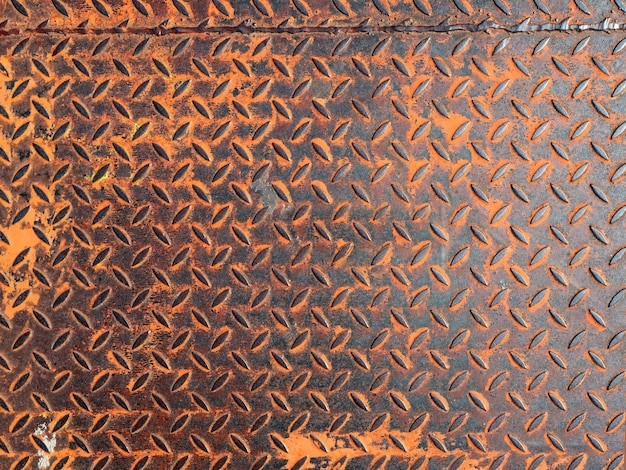 Rusty floor steel panel Grunge tread plate with orange rust