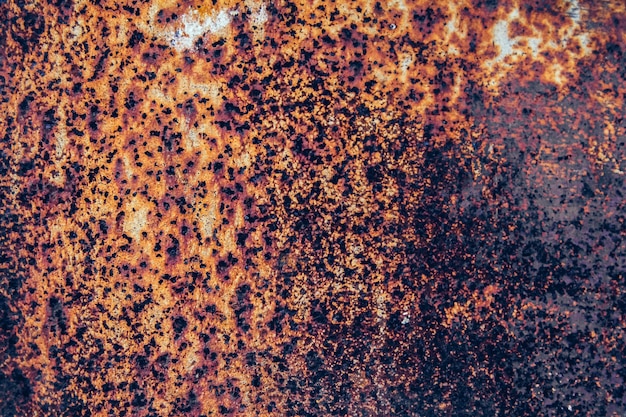 Rusty metal surface with blue paint residue as background image.