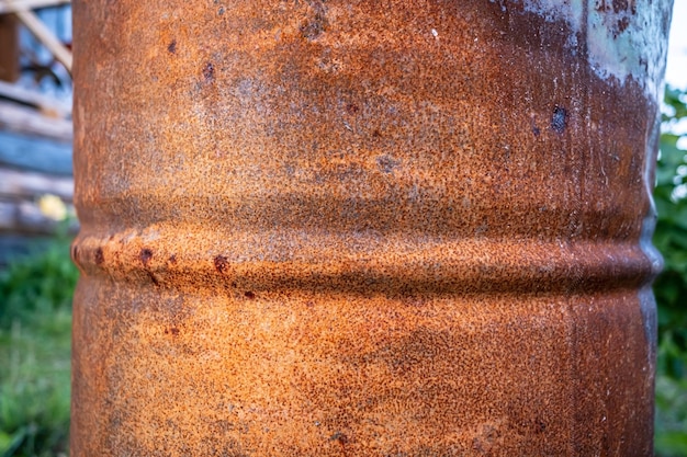 Rusty old barrel stands outdoors in the countryside Closeup