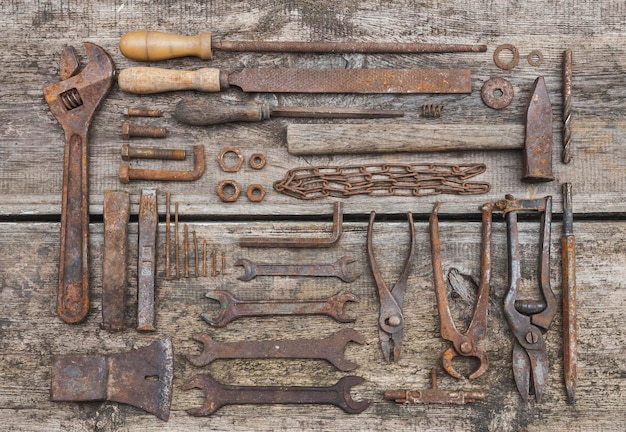 rusty tools lie on old wooden table