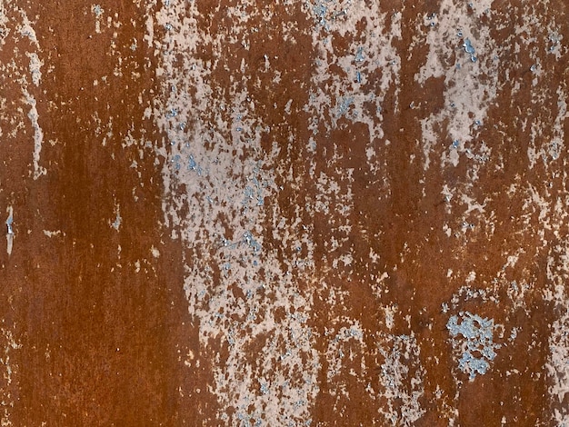 A rusty wall with blue paint on it