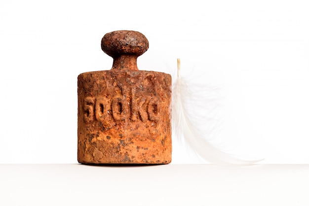 Rusty weight and plume isolated on white background.