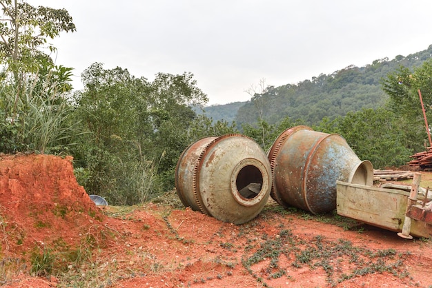 Rusty and worn concrete mixer abandoned outdoors