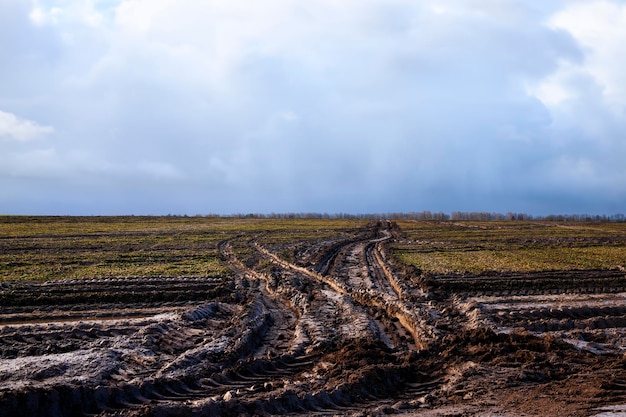 Ruts on the road for cars in the field in autumn after rains