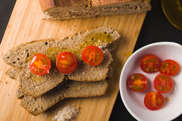 Rye bread, bread slices with cherry tomato, oil and salt, tomatoes cherry, oil and salt 