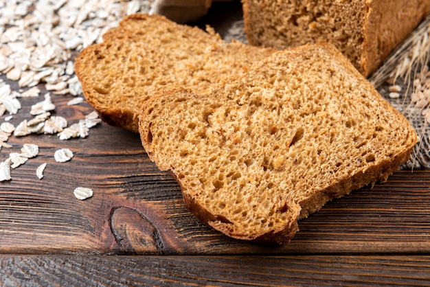 Rye bread on dark wooden table.