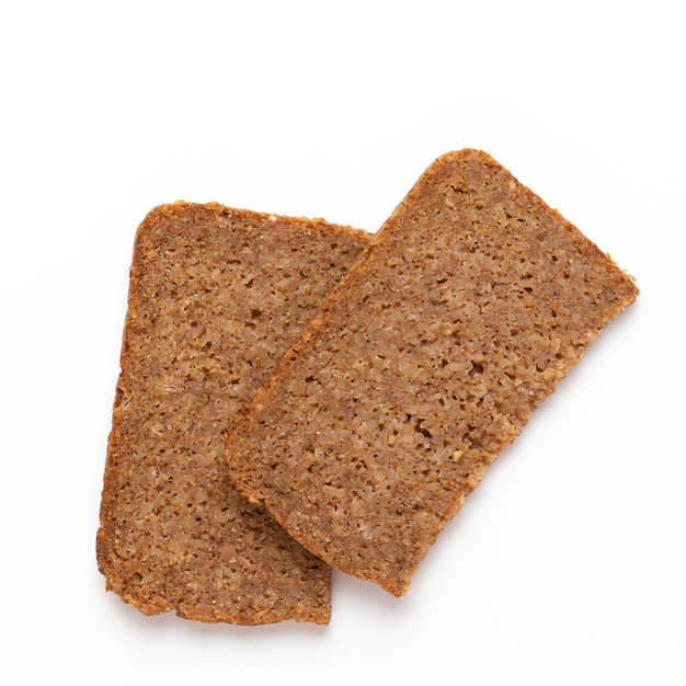 Rye bread slice on a white surface.  Flat lay.