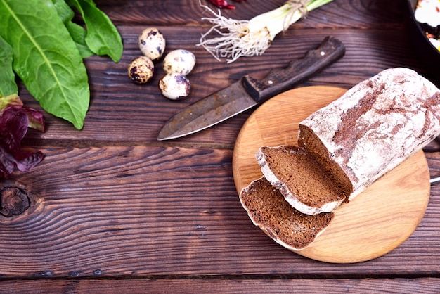 Rye bread sliced on a wooden surface kitchen board