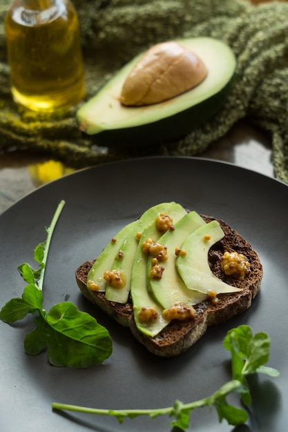 Rye bread with avocado and mustard seeds. Healthy food breakfast concept