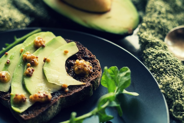 Rye bread with avocado and mustard seeds. Healthy food breakfast concept